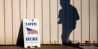 Image: A voter walks toward the entrance of the Boys and Girls Clubs of the Great Lakes Bay Region to cast their ballot in Bay City, Mich., during Election Day on Nov. 3, 2020.