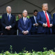 Vice President Kamala Harris, President Joe Biden, Michael Bloomberg, Donald Trump and JD Vance stand at the front of a barrier outside
