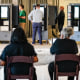 Voters cast ballots as election workers look on