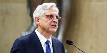 Merrick Garland speaks into a microphone
